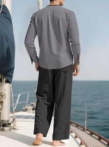 Men's grey linen long sleeve shirt and black trousers on a sunny yacht deck
