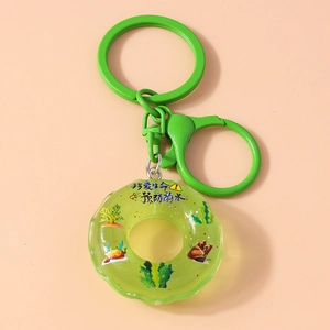 Detail of green lifebuoy keychain with safety message and matching carabiner clip