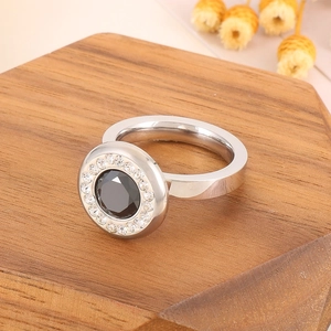 Close-up of a dual-layer stainless steel ring with a large black gemstone and white zircons