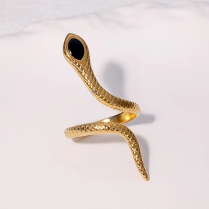 Exaggerated golden snake ring with black gemstone accents and detailed scale texture