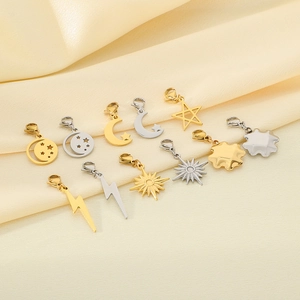 Detailed macro view of various stainless steel star and moon charms with lobster clasps