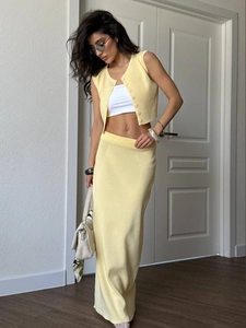 Women's yellow knit two-piece set featuring a cropped sleeveless vest and slim long skirt