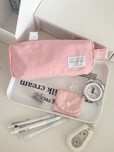 Pink minimalist padded pencil case with matching mini pouch and side handle detail