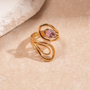 Detailed view of a gold spiral open ring featuring an oval pink zircon on a stone base