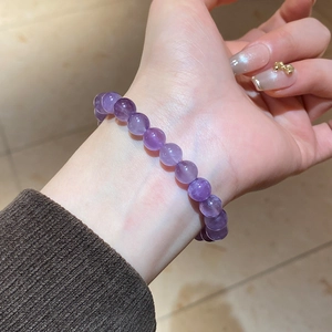 Detailed view of natural purple amethyst beaded bracelet on wrist with 10mm round beads