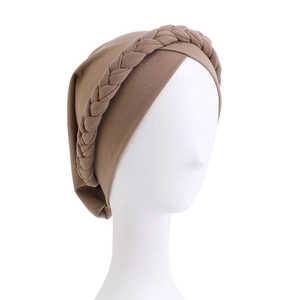 Detailed texture of brown braided turban cap with elegant twist design and soft knit fabric