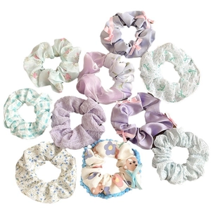 Floral and checkered fabric scrunchies set in assorted soft pastel colors and bow designs