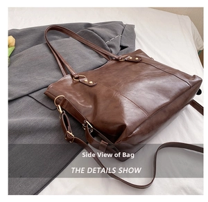 Side view of large brown tote bag with glossy finish and adjustable shoulder strap