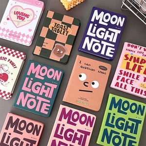 Flat lay of colorful A7 mini notebooks with various covers and English slogans