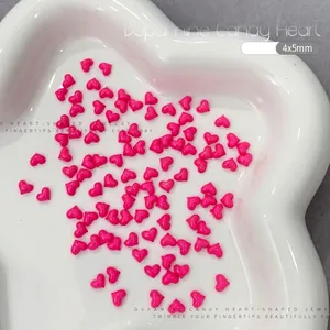 Macro shot of 4x5mm rose red resin heart charms for nail art and DIY jewelry