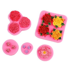 Close-up of 5 pink silicone flower molds with detailed rose and peony textures