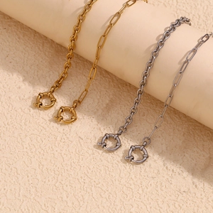 Detail of paperclip and round link chains in gold and silver finish with spring ring clasps
