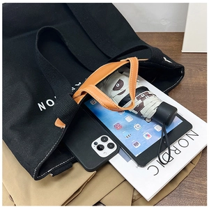 Top view of large canvas tote bag showing interior capacity with tablet and umbrella