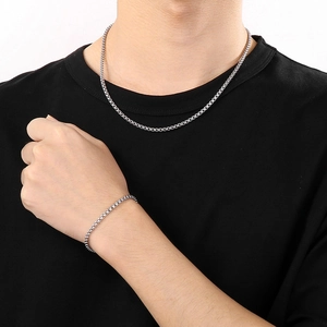 Minimalist silver stainless steel box chain necklace and bracelet set worn by a male model