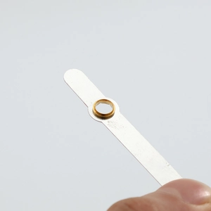 Macro shot of silver aluminum clock hands with a gold center hub for quartz movement