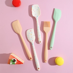 Silicone baking spatula set and pastry brush in pastel colors for kitchen cooking tasks.