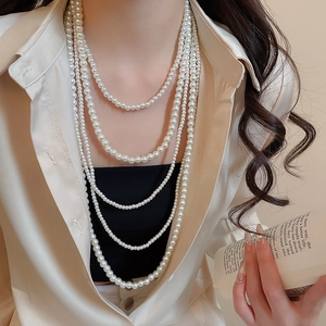 Close-up of elegant 5-layer pearl necklace showing gradient bead sizes and warm luster