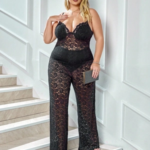 Detail of sheer floral lace texture and deep V-neckline on a black lace jumpsuit