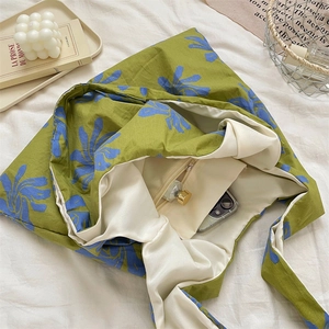 Detail view of large canvas tote with blue floral print and internal zipper pocket