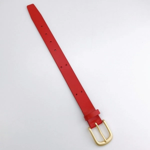 Detail view of red leather wrist strap with gold metal buckle and adjustment holes