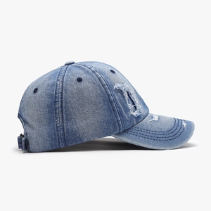 Vintage washed light blue denim baseball cap with distressed ripped details and metal buckle