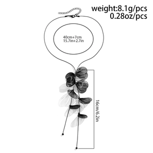 Detailed view of black mesh ginkgo leaf fringe necklace with adjustable chain sizing