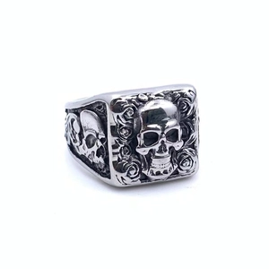 Macro detail of Gothic skull and rose relief on vintage silver titanium steel ring