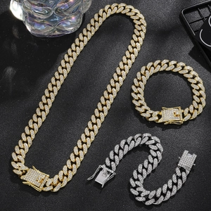Detailed macro view of 14mm iced out Cuban link chains in gold and silver finish