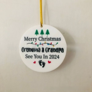 Detail of white round ceramic Christmas ornament for Grandma & Grandpa with gold string