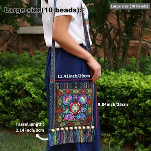 Close-up of ethnic crossbody bag with floral embroidery and colorful long tassels