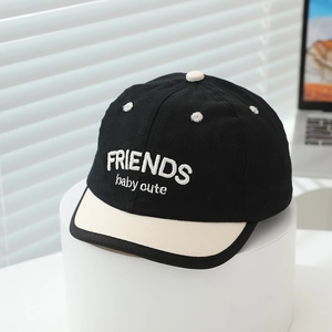 Detail view of cotton baby baseball cap featuring contrast color and Friends embroidery