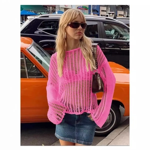 Neon pink long sleeve crochet beach cover-up with open-knit texture for summer vacation
