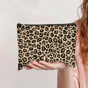 Detailed close-up of the leopard print canvas makeup bag with a sturdy metal zipper closure