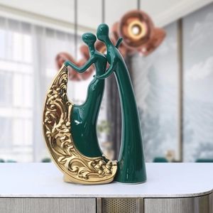 European style dark green ceramic couple figurines with golden floral embossment