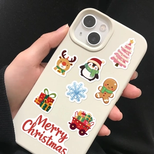 Detail of waterproof Christmas stickers with reindeer and ginger man on a mobile phone case