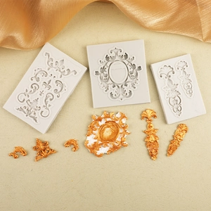 Macro detail of Baroque style silicone molds with golden embossed floral patterns