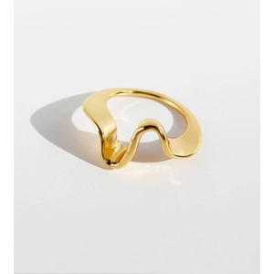 Minimalist gold plated brass wave ring featuring an irregular geometric design on white background