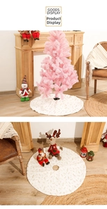 Detail of white faux fur Christmas tree skirt with golden foil feather patterns