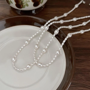 Minimalist 925 sterling silver necklace with irregular white pearls on vintage ceramic