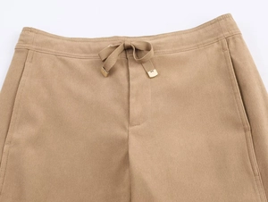 Détail du pantalon large kaki avec taille élastique à cordon et embouts métalliques