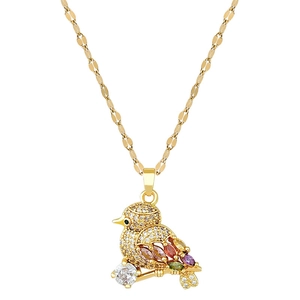 Luxurious gold bird necklace with colorful crystals and micro-pave cubic zirconia on white background