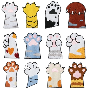 Detailed grid of twelve cartoon cat paw embroidery patches in various feline colors