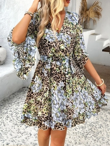 Detail of V-neck chiffon dress with leopard and floral print and waist tie design