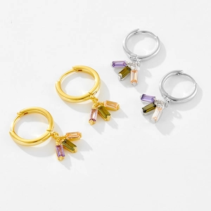 Detail of square colorful crystals hanging on gold and silver hoop earrings