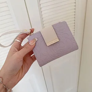 Lavender floral embossed bifold wallet with wristlet strap and chic snap closure
