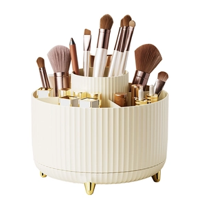 Rotating cream makeup brush holder with gold legs and compartments for cosmetics