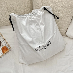 Detailed view of the linen drawstring dust bag featuring a minimalist black edition print