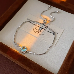 Detailed macro view of square light blue gemstone bracelet in premium velvet jewelry box