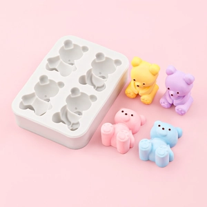 Silikonform mit 4 Mulden für kleine Bären und bunte Teddybären auf rosa Grund