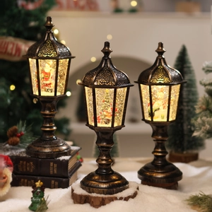 Close-up of vintage bronze Christmas lanterns with snow globe effects and festive figures